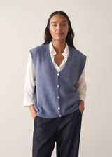 Woman wearing a blue sleeveless knitted waistcoat