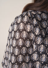 Woman wearing cotton block print dress with tiered skirt