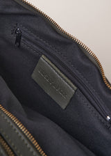 Inside view of khaki green leather sling banana bag with zip fastening