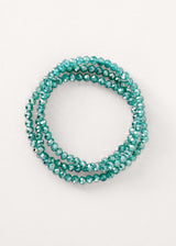 Teal blue crystal bracelet on neutral background