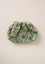 Green embroidered sequin clutch bag on a beige background