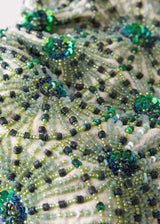 Close up of embroidery on a green embroidered sequin clutch bag