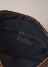 Bronze-coloured leather clutch bag with fringe details on a light gray background