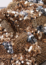 Close up of sequin detail on a gold embellished clutch bag