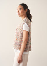 Woman wearing space dye knitted vest top with white t-shirt and light trousers