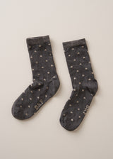 Grey cotton blend socks with metallic silver star accents and sparkle detail on the ankle, on a beige background