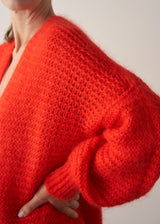 Woman wearing bright red mohair blend cardigan