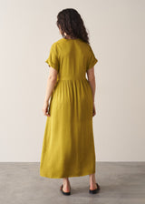 Woman wearing chartreuse yellow satin midi dress