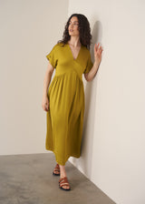 Woman wearing chartreuse yellow satin midi dress