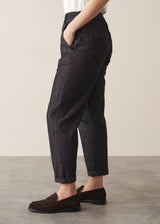 Woman wearing blue black straight leg denim jeans