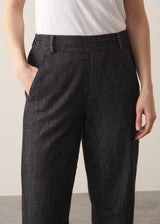 Woman wearing blue black straight leg denim jeans