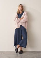 Woman wearing navy blue wide leg linen trousers with matching linen shirt