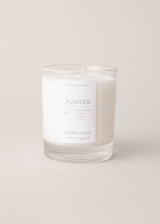 Powder scented candle with notes of black pepper and lemon, on a beige background