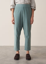 Woman wearing corduroy tapered trousers in aqua and pale checked shirt