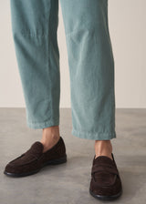 Woman wearing corduroy tapered trousers in aqua and pale checked shirt