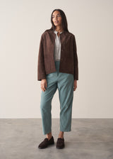 Woman wearing corduroy tapered trousers in aqua and pale checked shirt