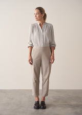 Woman wearing light blue and white check blouse