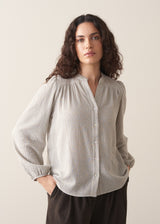 Model wearing pale checked shirt and brown corduroy trousers