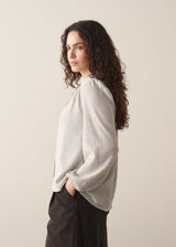 Model wearing pale checked shirt and brown corduroy trousers