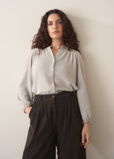 Model wearing pale checked shirt and brown corduroy trousers