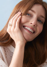 Woman wearing chunky gold crystal adorned ring