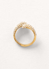 Chunky gold crystal adorned loop ring on neutral background