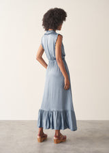 Woman wearing a dusky blue satin midi dress standing against a plain background