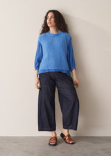 Woman wearing cobalt blue cotton top and blue jeans