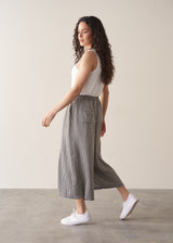 Woman wearing white shirt and stripe wide leg cropped trousers