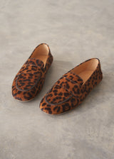 Pair of leopard print loafers on a grey surface