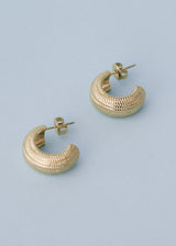 Textured gold hoop cuff earring on blue background