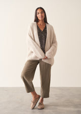 Woman wearing silk blend leopard print blouse and khaki trousers