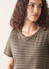 Woman wearing khaki stripe t-shirt and blue wide leg jeans