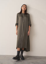 Woman wearing a long dark green satin dress