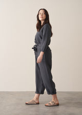 Woman wearing a dark charcoal grey linen jumpsuit