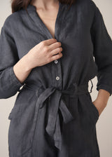 Woman wearing a dark charcoal grey linen jumpsuit