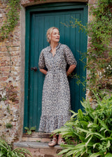 Woman in a garden wearing a leopard print dress
