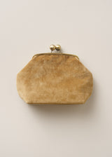 A vintage-style hexagonal clutch purse in a textured tan suede or velvet material, featuring a brass-tone metal kiss-lock clasp with two decorative pearl-like beads on top, set against a plain light beige background.