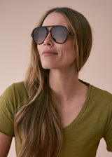 A model wearing a pair of tortoiseshell aviator sunglasses