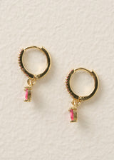 Gold hoop earrings with red crystal detail