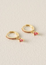 Gold hoop earrings with red crystal detail