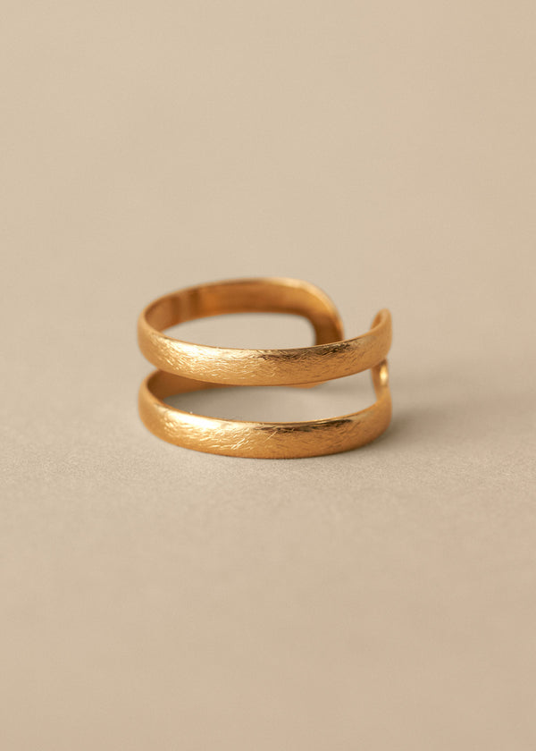 Gold ring on a beige background