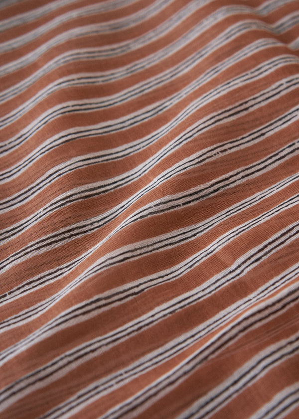 Close-up of brown fabric with thin black stripes