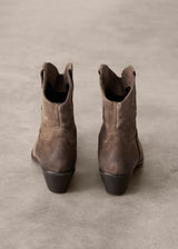 Pair of brown leather boots on a beige background