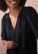 Black embroidered top with scallop hem and tassel details