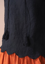 Black embroidered top with scallop hem and tassel details