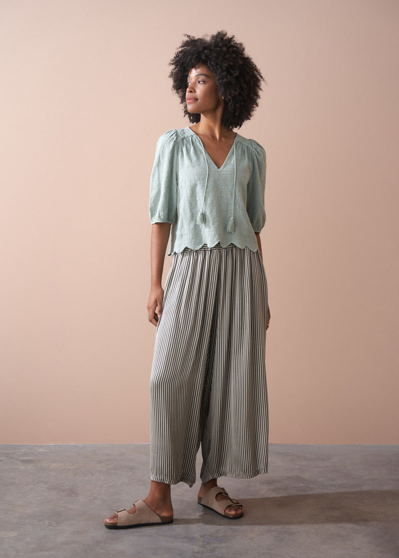 Sage green embroidered top with tassel detail