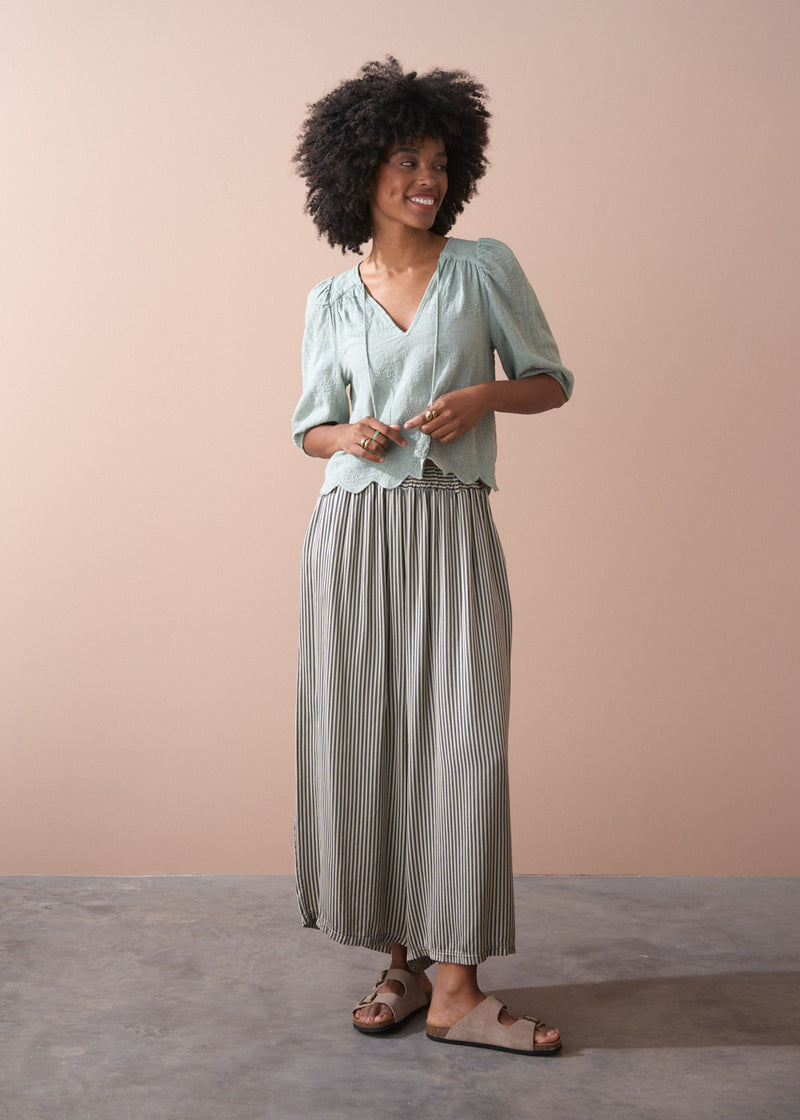 Sage green embroidered top with tassel detail