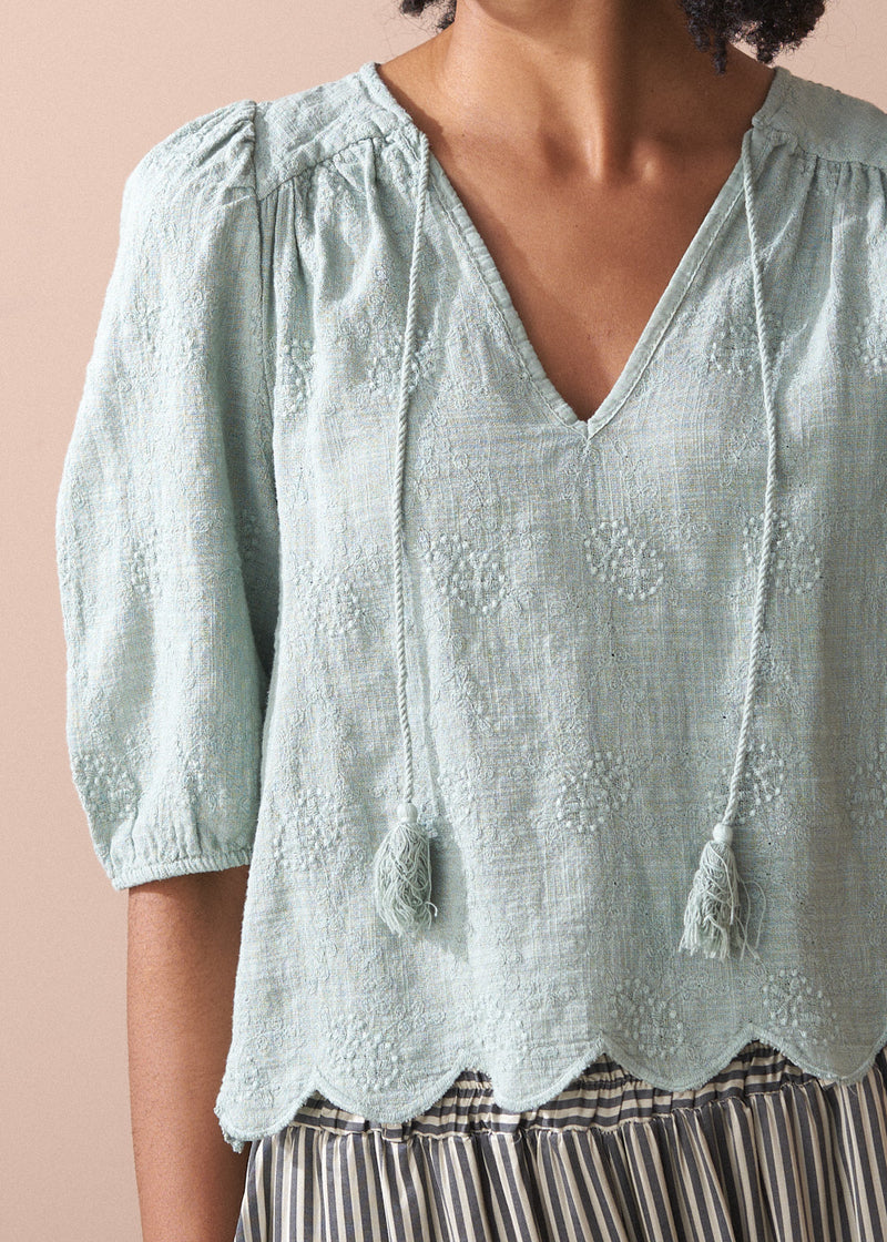 Sage green embroidered top with tassel detail