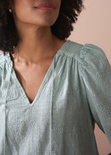 Sage green embroidered top with tassel detail